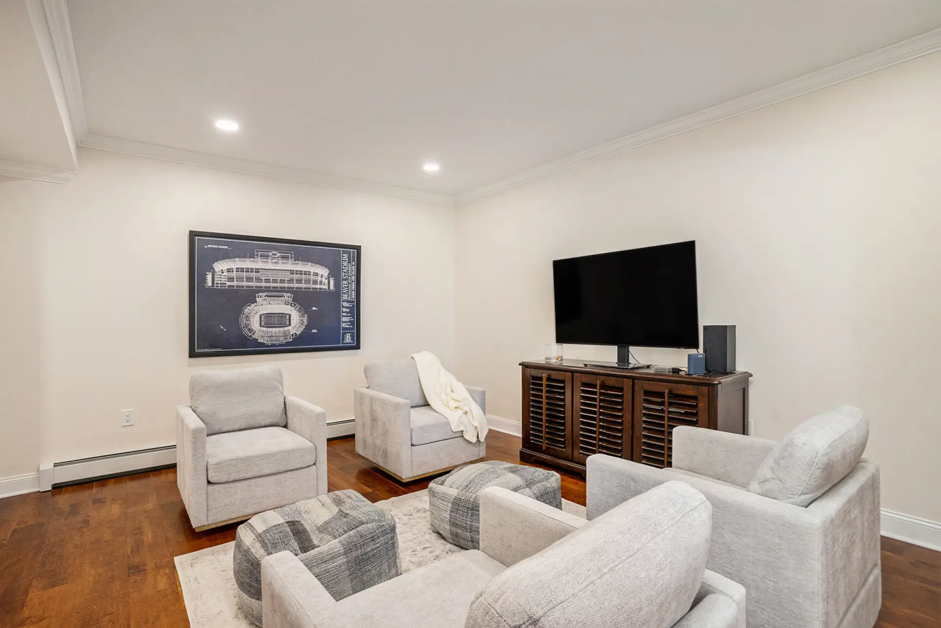 Basement media den with swivel seating — Harlan Custom Contracting project