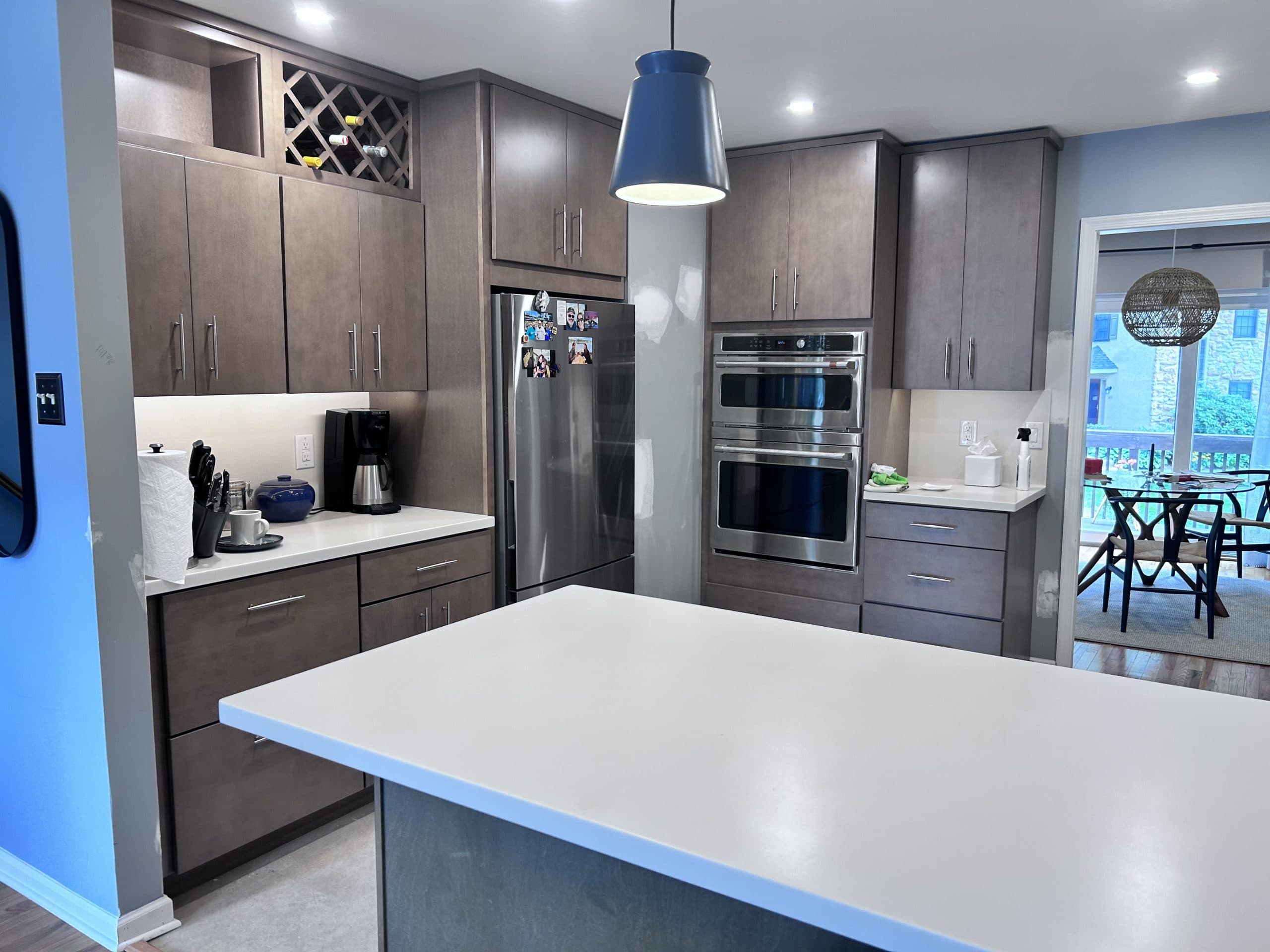 Kitchen remodel with gray flat-panel cabinetry, quartz island, and double wall oven — Harlan Custom Contracting project