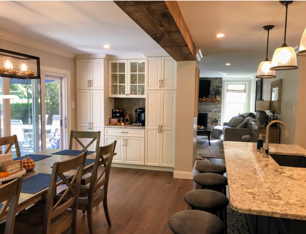 Open-concept interior renovation with custom cabinetry wall by Harlan Custom Contracting