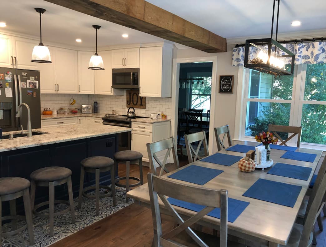 Farmhouse kitchen remodel with navy island, exposed beam, and subway tile — Harlan Custom Contracting project