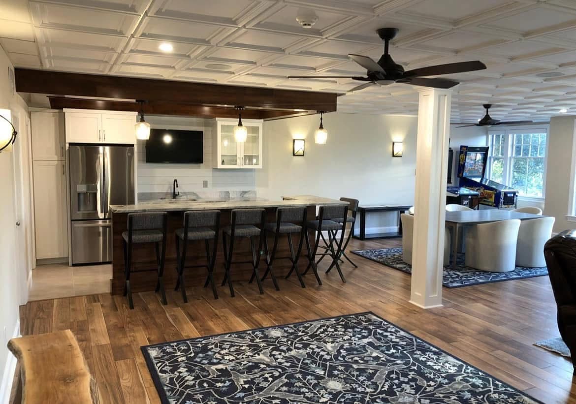 Finished basement with coffered ceiling detail, custom bar, and game room — Harlan Custom Contracting project
