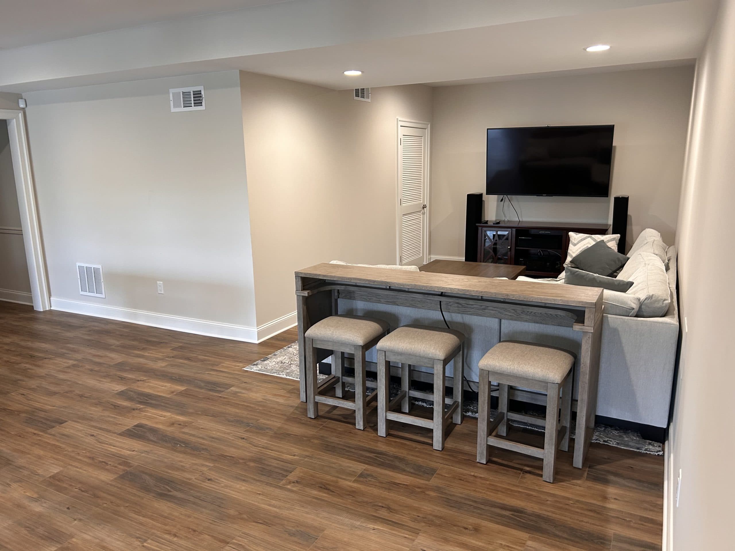 Finished basement with luxury vinyl plank flooring installed by Harlan Custom Contracting